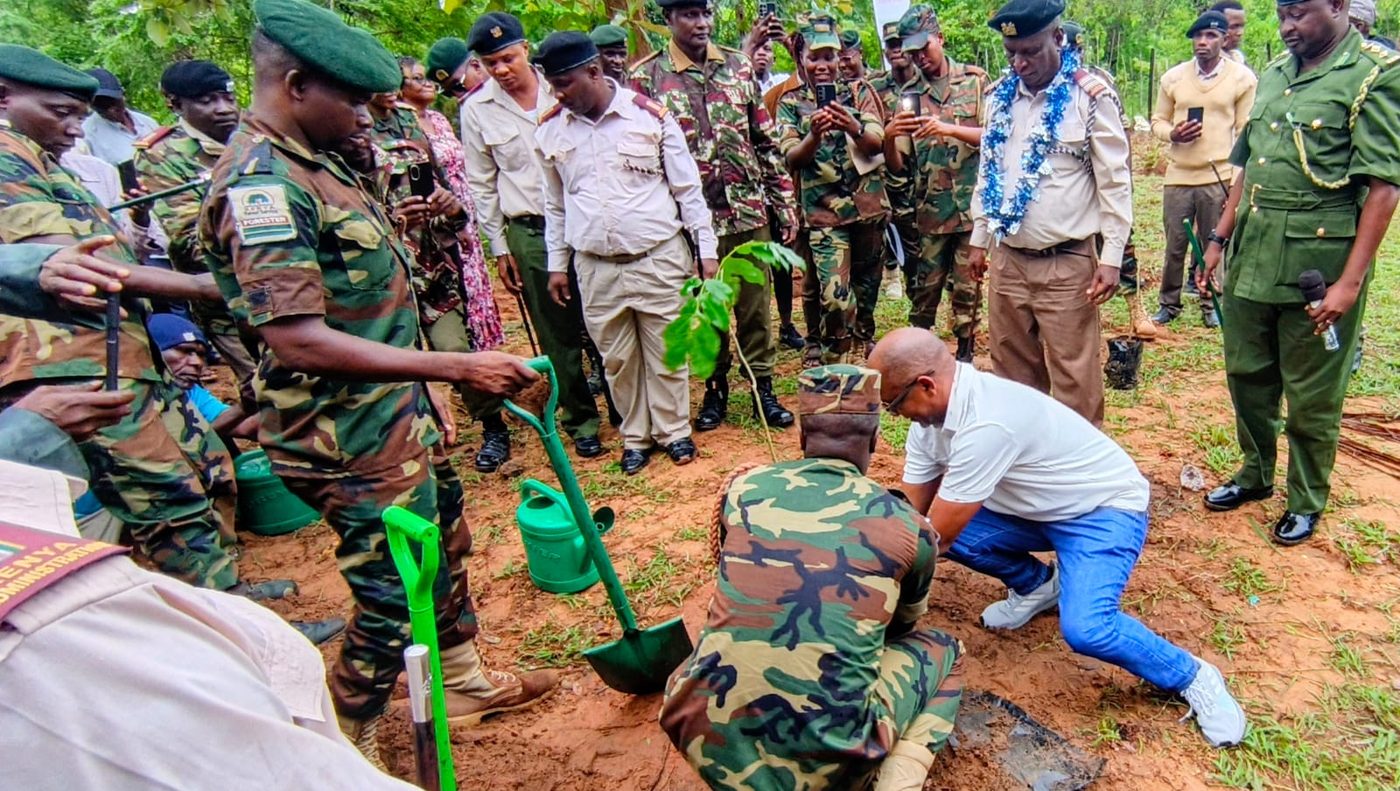Officials and community members planting trees at a community event