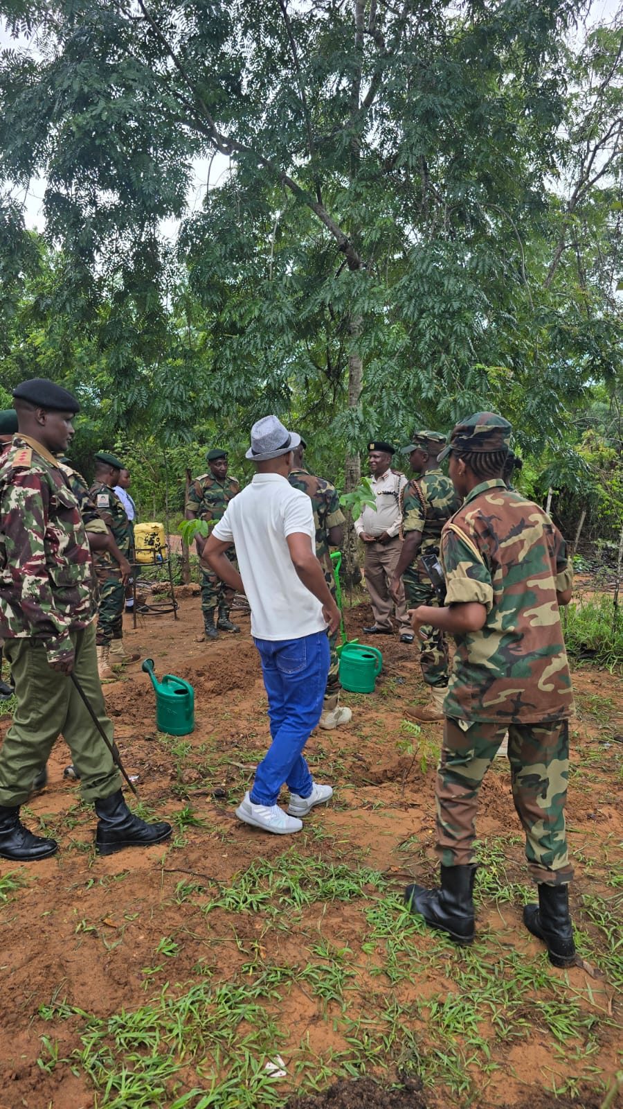 Rangers and community members at a tree-planting ceremony